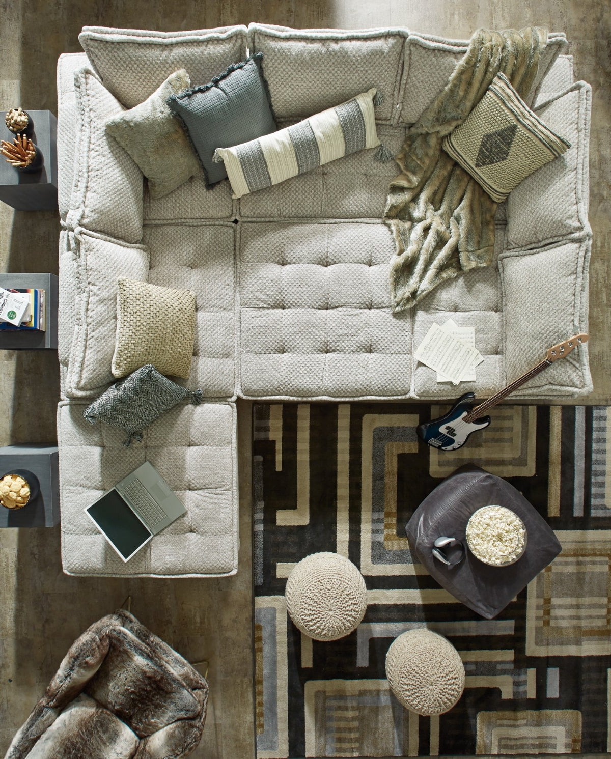 Top view of a living room sectional sofa with pillows and a patterned rug at Milwaukee Furniture.