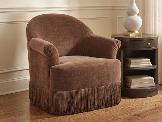 Rust brown accent chair on a round rug in a living room