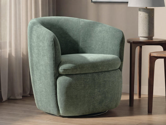 Green barrel chair on a round rug in a living room