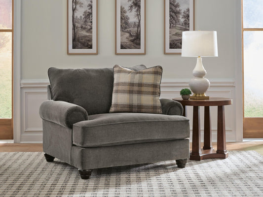 Dark gray upholstered chair on a patterned living room rug