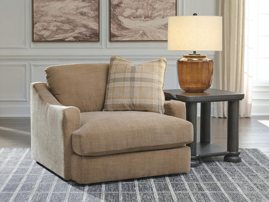 Tan oversized chair beside a wooden side table in a living room