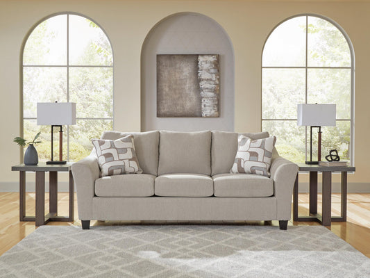 Beige living room seating beneath arched windows