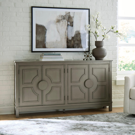 Olive gray accent cabinet styled beneath a mirror in a bright room