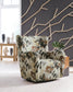 Floral accent chair beside a side table and patterned wall