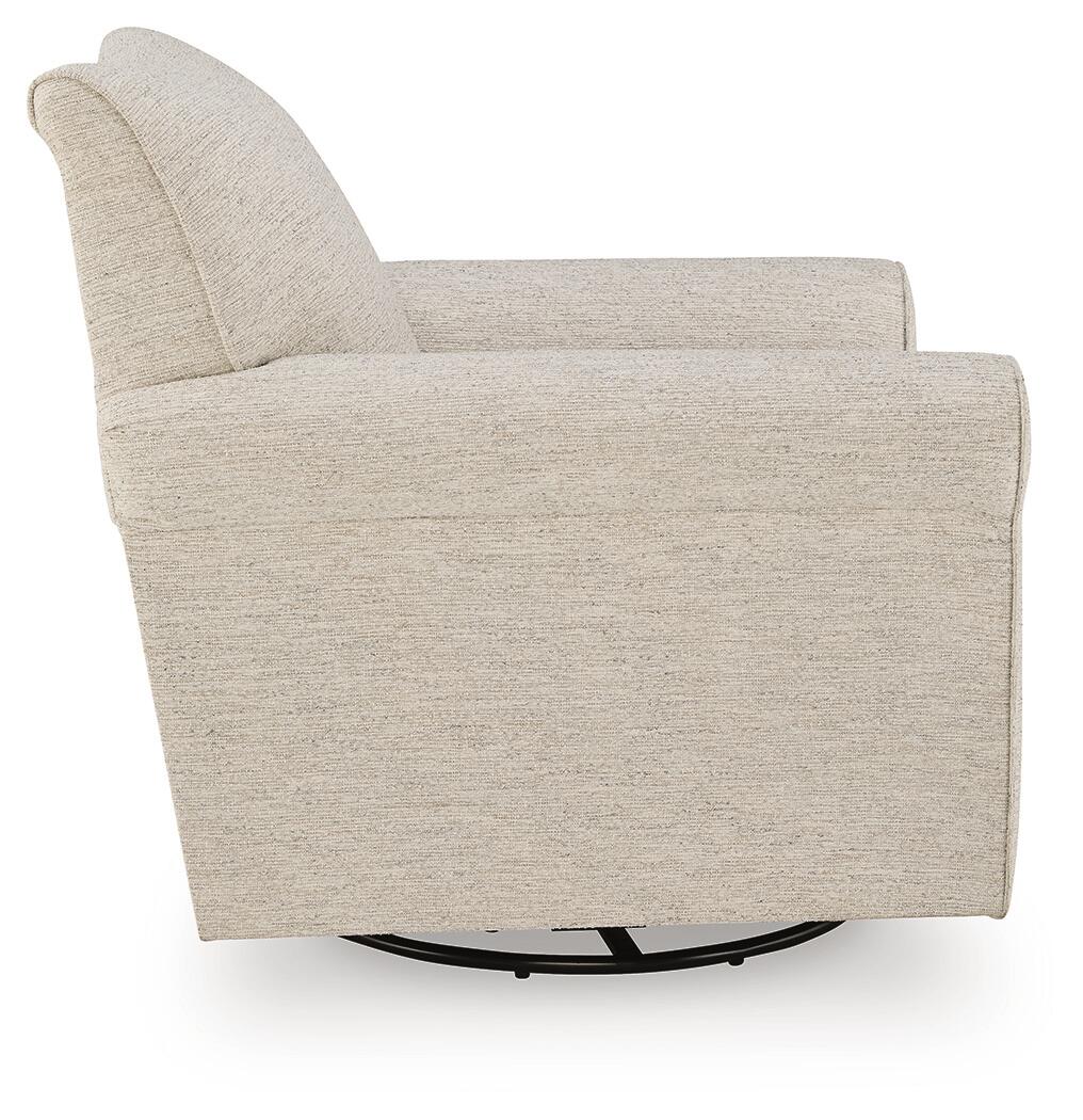 Cream upholstered accent chair with a round black base, side view