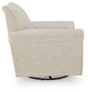 Cream upholstered accent chair with a round black base, side view