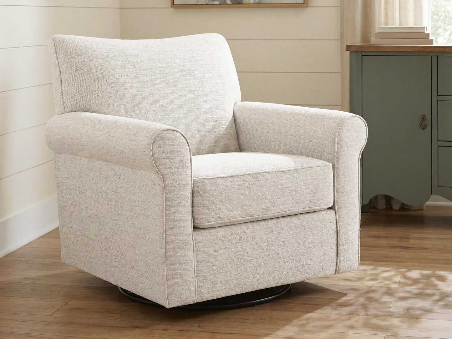 Cream upholstered accent chair on a patterned living room rug