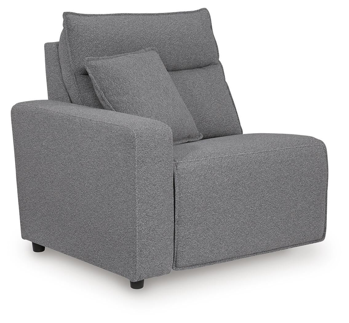 Gray sectional seat with one arm and an accent pillow, angled view
