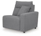 Gray upholstered sectional seat with one arm and an accent pillow
