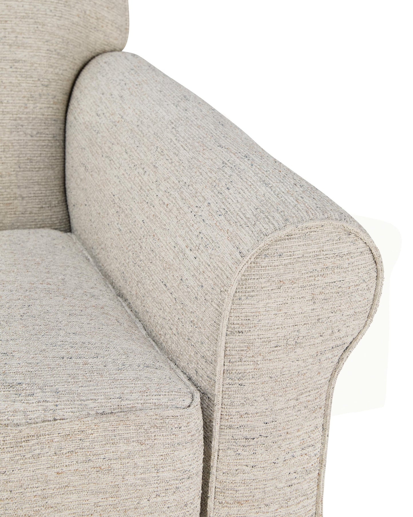 Close-up of a cream accent chair's rounded arm and seat