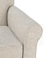 Close-up of a cream accent chair's rounded arm and seat