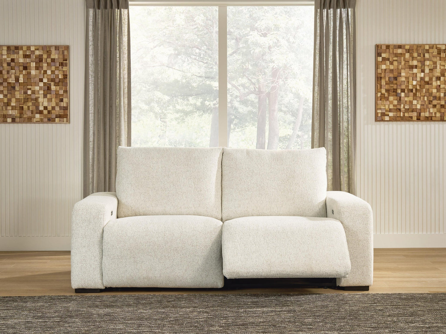 Cream loveseat with an extended footrest in a furnished living room
