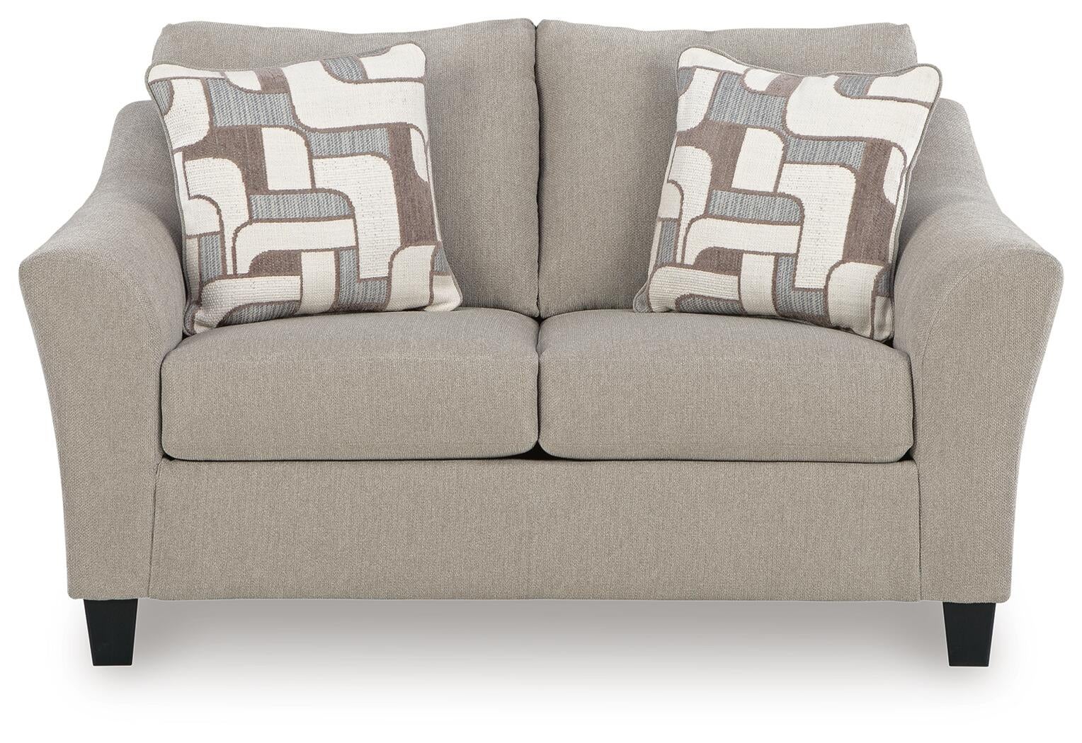 Beige upholstered accent chair with patterned pillows, front view