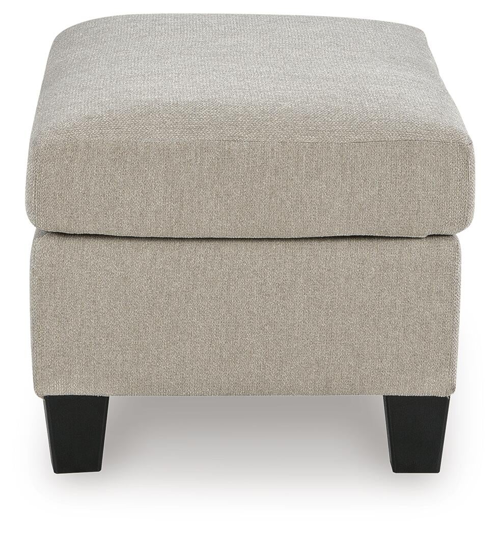 Beige upholstered ottoman with dark legs, end view