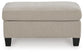 Beige rectangular upholstered ottoman with dark legs, front view