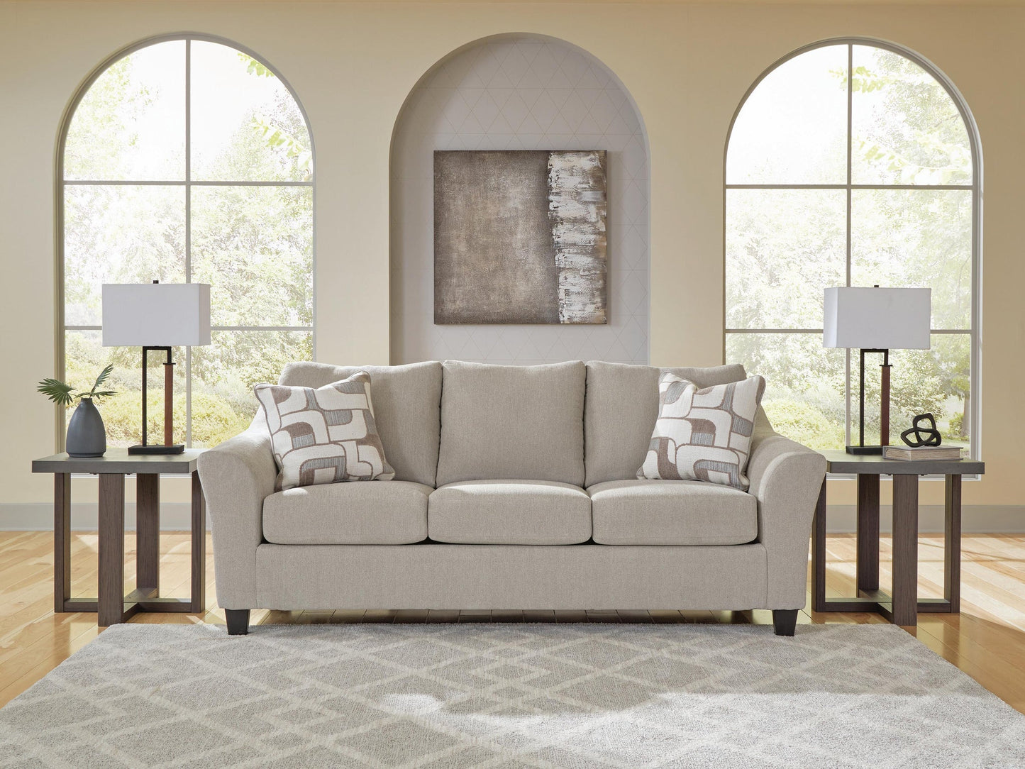 Beige living room seating beneath arched windows