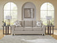 Beige living room seating beneath arched windows