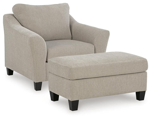 Beige upholstered armchair with a matching rectangular ottoman